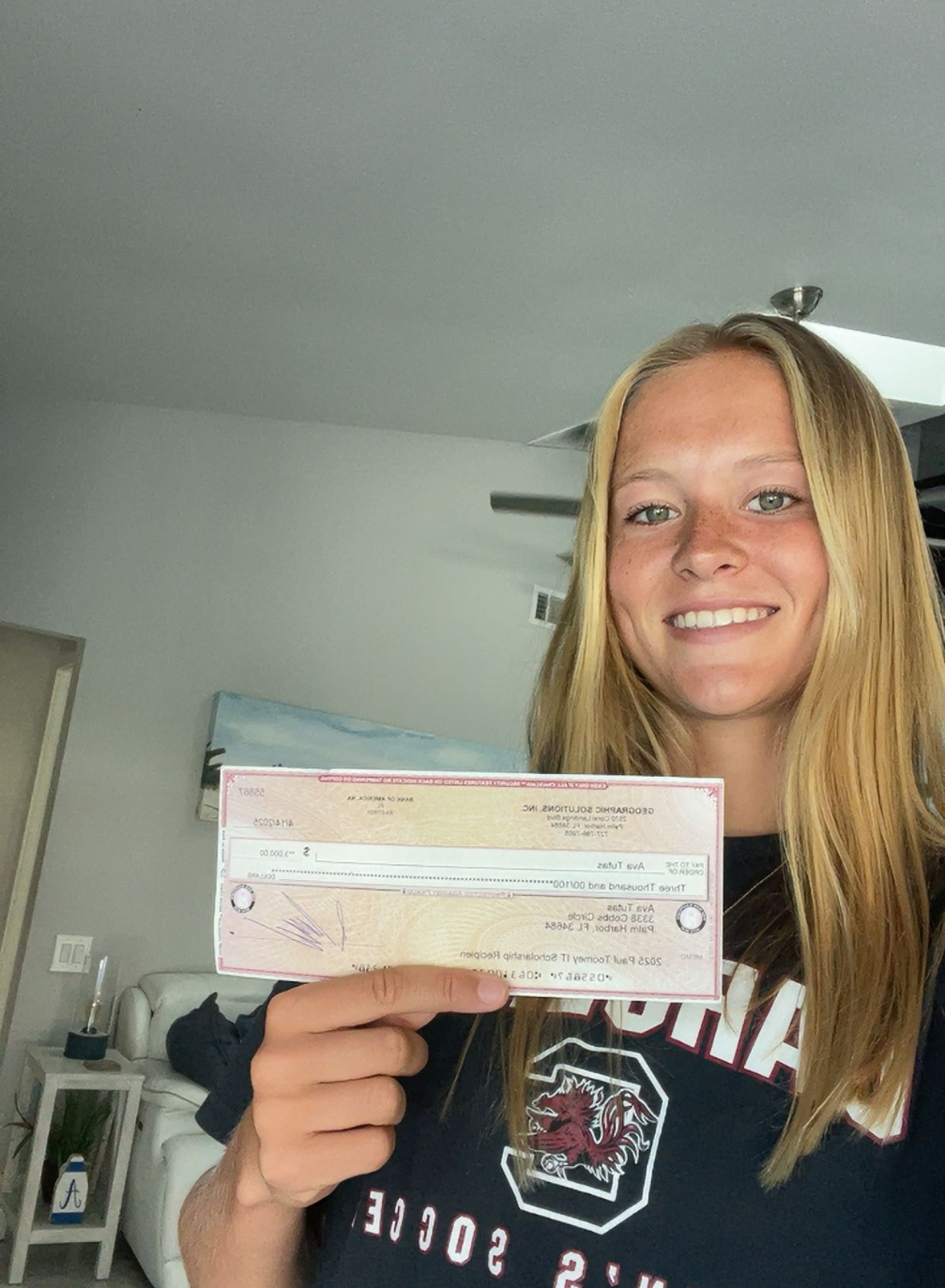 Ava Tutas holding IT Scholarship Award check